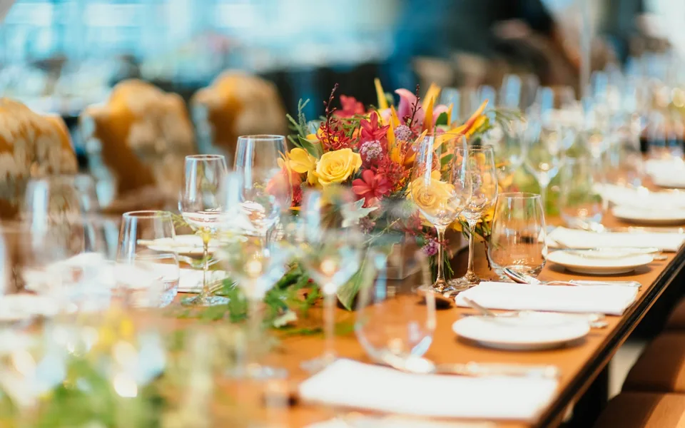 Event table setting with flowers and glassware.