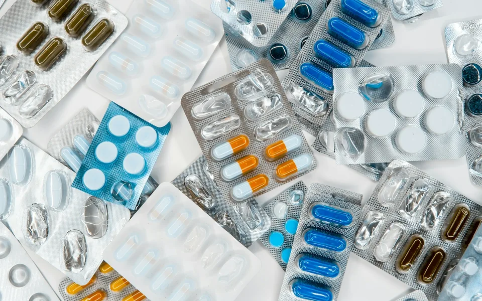 Medicine blister packs arranged on a white surface.