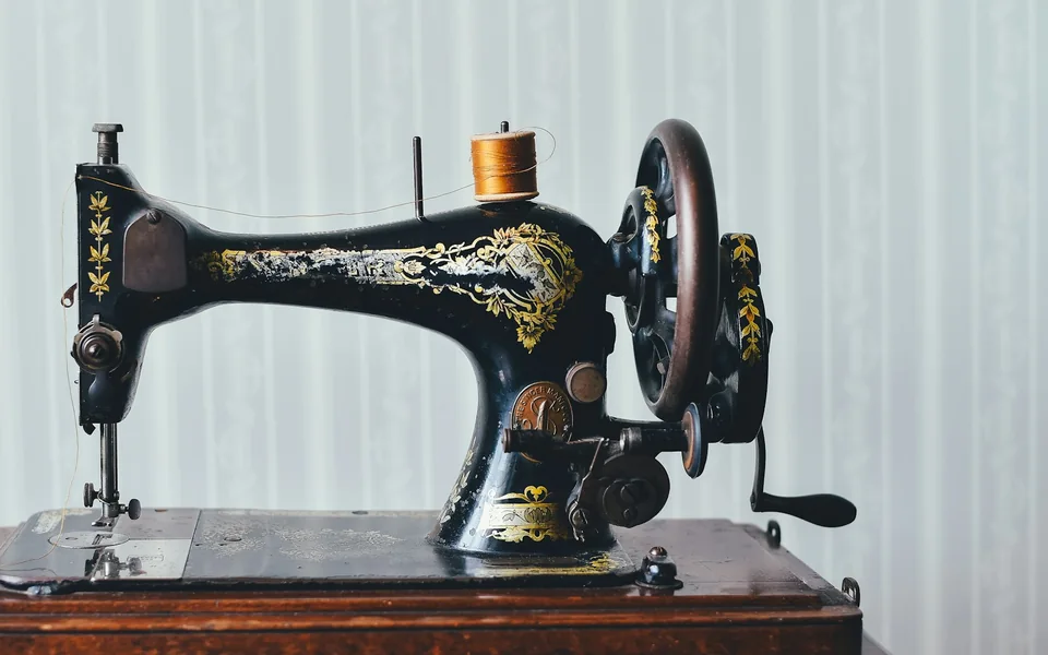Vintage sewing machine on a work table.